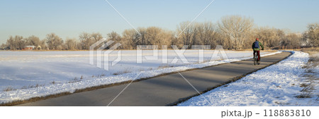 male cyclist commuting on a bike trail in winter scenery - Poudre River Trail panorama in northern Colorado 118883810