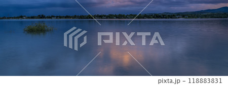 dramatic sunset sky and  clouds over Rocky Mountains and lake in northern Colorado 118883831