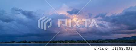 dramatic sunset sky and  clouds over Rocky Mountains and lake in northern Colorado 118883832