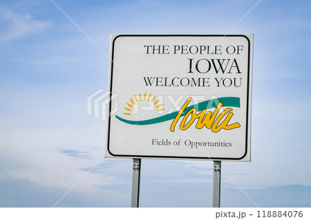 Iowa welcome roadside sign against blue sky at state border with Missouri,  travel concept 118884076