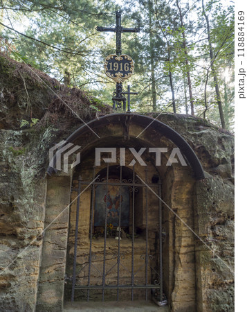 Rock chapel Holy Trinity carved into the sandstone rock near Ceska Kamenice town in Lusatian Mountains forest 118884169