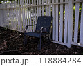 Blue chair by white fence in shade 118884284