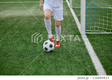 And the soccer player in the uniform and red clothes controlling the soccer ball on the Green Field And the soccer player in the uniform and red clothes controlling the soccer ball on the Green Field 118884813
