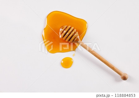 honey spoon with spilled honey on white background, top view honey spoon with spilled honey on white background, top view 118884853