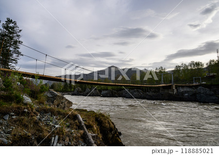 Elekmonar, Altai Republic, Suspension bridge over fast mountain river Katun. Sharp rocky islands in the middle of Katun river 118885021