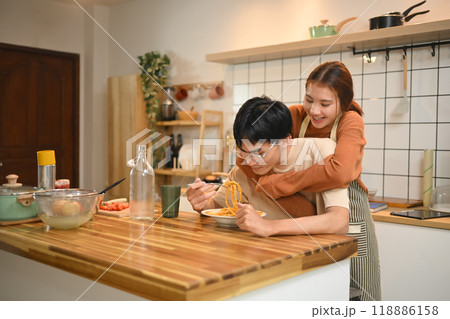 Loving young couple enjoying a casual meal in kitchen. People, food and lifestyle concept Loving young couple enjoying a casual meal in kitchen. People, food and lifestyle concept 118886158