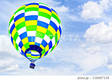 Colorful hot air balloon flying over blue sky with white clouds 118887130