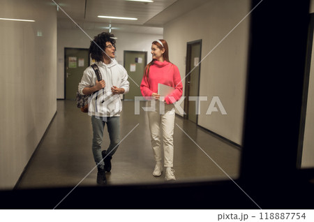 Two young people in the corridor talking and looking involved 118887754