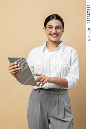 Attractive happy enjoying online shopping on tablet Attractive happy enjoying online shopping on tablet 118887811