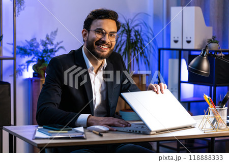 Indian businessman freelancer at office workplace working on laptop computer sends online messages 118888333