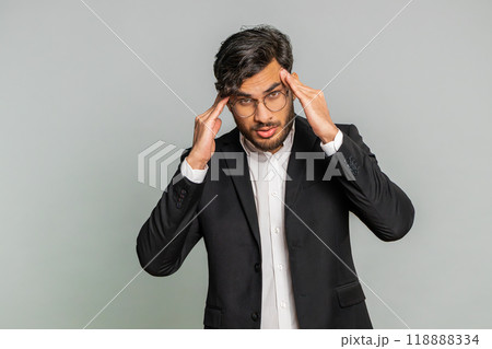 Indian man rubbing temples to cure headache problem, suffering from tension and migraine stress pain 118888334