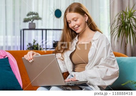 Teenager girl freelancer starts working on laptop, sends messages, makes online purchases at home Teenager girl freelancer starts working on laptop, sends messages, makes online purchases at home 118888418