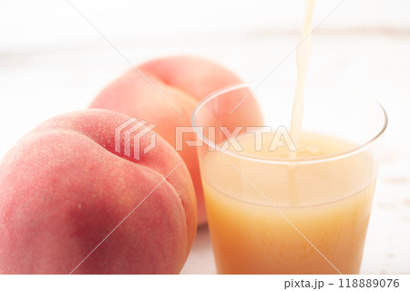 コップに注がれるピーチジュースのクローズアップ 118889076