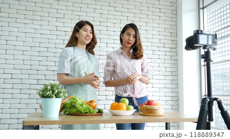 Asian influencer vlogger live review healthy eating lifestyle. Two Young woman friends blogger vlog happy lifestyle how to eating vegetables, fruit, vegan products. Two women talk social media vlog Asian influencer vlogger live review healthy eating lifestyle. Two Young woman friends blogger vlog happy lifestyle how to eating vegetables, fruit, vegan products. Two women talk social media vlog 118889347