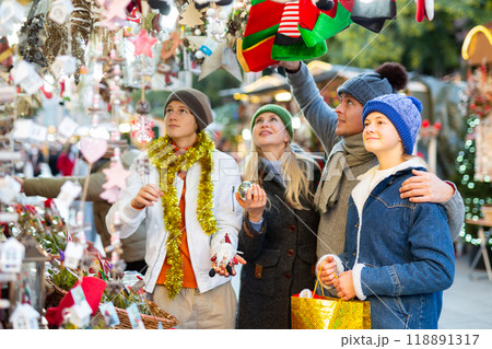 Family of four choosing decorations at Christmas fair Family of four choosing decorations at Christmas fair 118891317