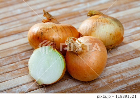 Ripe onions on wooden table Ripe onions on wooden table 118891321