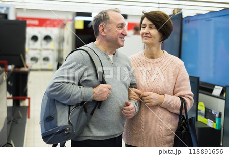 Mature man and woman shopping in appliance store Mature man and woman shopping in appliance store 118891656