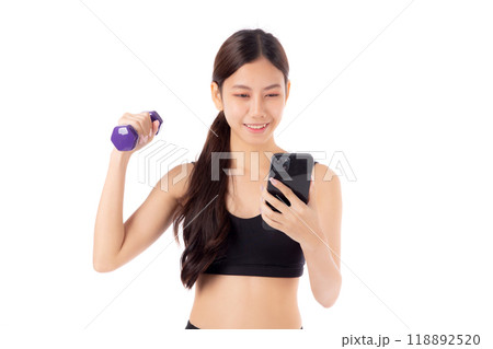 Portrait young asian woman lifting dumbbell and watching smartphone isolated. 118892520