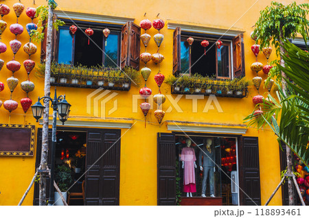facade of an ancient Asian house decorated with colorful hanging Chinese lanterns for a holiday in old town in Hoi An in Vietnam 118893461