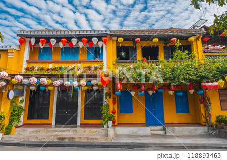 facade of an ancient Asian house decorated with colorful hanging Chinese lanterns for holiday in the old town in Hoi An in Vietnam 118893463
