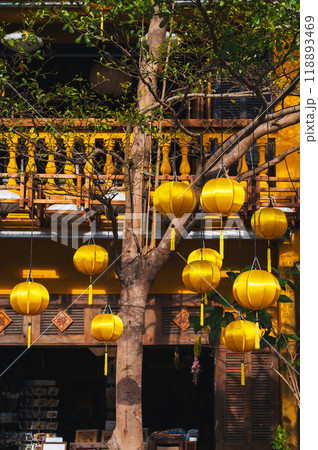 facade of an ancient Asian house decorated with yellow hanging Chinese lanterns for holiday in old town in Hoi An in Vietnam facade of an ancient Asian house decorated with yellow hanging Chinese lanterns for holiday in old town in Hoi An in Vietnam 118893469