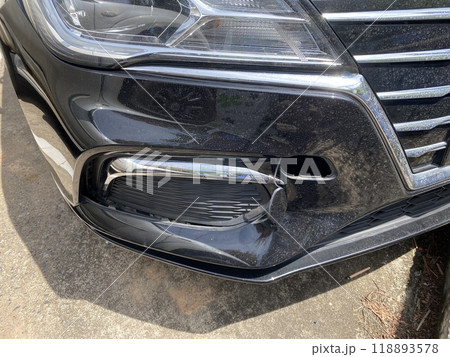 Close-up of the headlight of a modern black car after accident on the road Close-up of the headlight of a modern black car after accident on the road 118893578