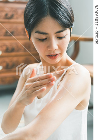 ボディクリームを腕に塗る若い女性 118893676