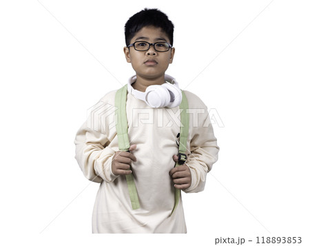 Portrait of boy in casual clothes carry a green bag and white headphones isolated on a white background, The concept of education and way of life. Cute boy posing in casual clothes with clipping part. Portrait of boy in casual clothes carry a green bag and white headphones isolated on a white background, The concept of education and way of life. Cute boy posing in casual clothes with clipping part. 118893853