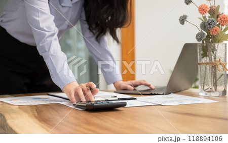 Businesswoman hand holding pen, analysis the graph with laptop at the home office for setting challenging business goals And planning to achieve the new target Businesswoman hand holding pen, analysis the graph with laptop at the home office for setting challenging business goals And planning to achieve the new target 118894106