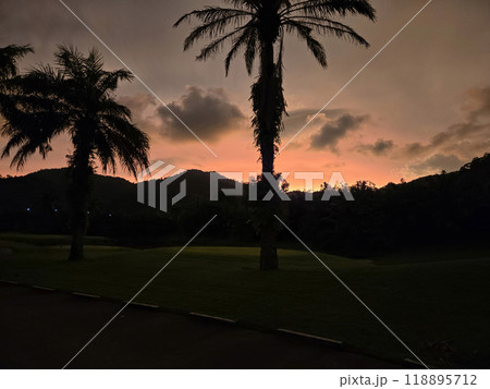 sunset in thailand of mountains, palm trees and clouds sunset in thailand of mountains, palm trees and clouds 118895712