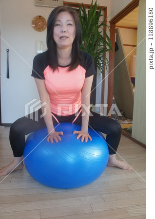 バランスボールに乗る長身女性 118896180
