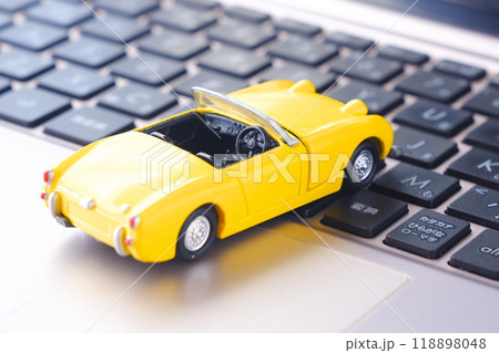 ふたり乗りのオープンカーと、ノートパソコン 118898048