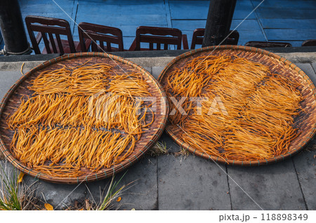 dried fish sticks are dried in sun at a market in Vietnam in Asia 118898349