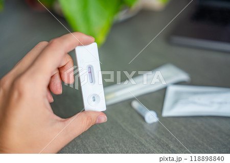 Rapid Antigen Test kit with with negative result during swab COVID-19 testing. Coronavirus Self nasal or Home test, Autumn exacerbation of viruses Rapid Antigen Test kit with with negative result during swab COVID-19 testing. Coronavirus Self nasal or Home test, Autumn exacerbation of viruses 118898840