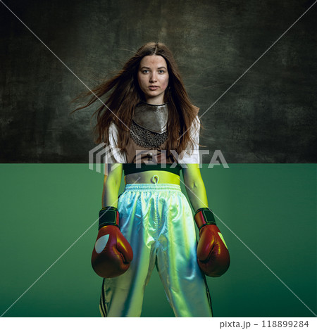 Warrior boxer. Creative collage. Medieval warrior from the waist up, holding a sword, paired with a boxer in modern boxing shorts. 118899284