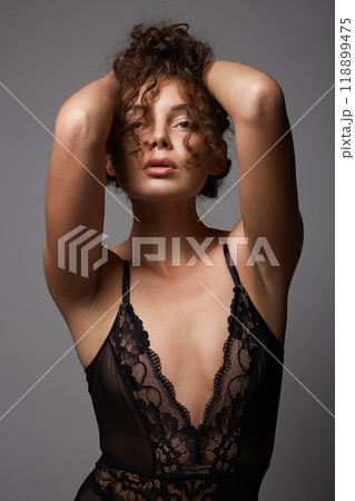 beautiful young woman with curly hair. pretty sexual girl in underwear beautiful young woman with curly hair. pretty sexual girl in underwear 118899475