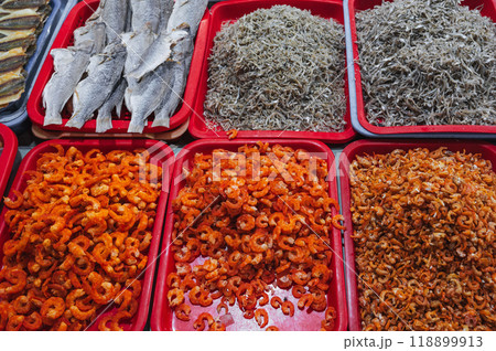 dried fish, shrimp and anchovies seafood on counter at the fish market in Asia in Vietnam 118899913