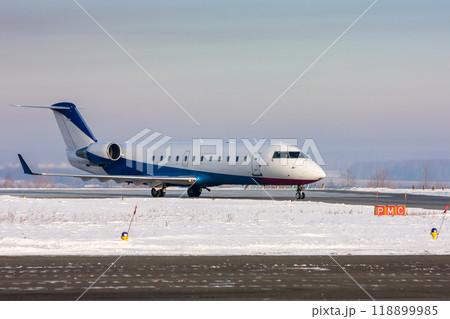 Private plane on the main taxiway at winter 118899985