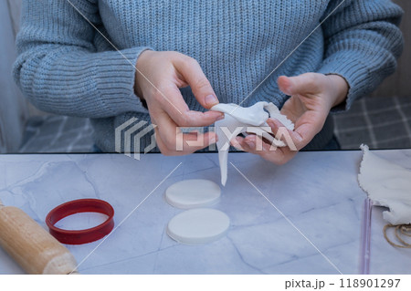Unrecognizable artist do it yourself air dry clay crafts for Christmas tree decor holiday. Decoration gift idea Handmade children craft. Step by step instruction of painting 118901297