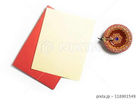 Red envelope with blank yellow paper sheets and clay oil lamps on white background to wish Diwali festival 118901549