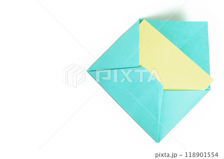 Envelope with yellow paper sheet isolated on white background with copy space for text. 118901554