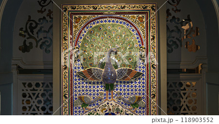 Replica Of Peacock Mosaic Wall From Mor Chowk Or Peacock Square Of Udaipur City Palace. Peacocks Have Been Crafted With 5000 Pieces Of Glass, Which Shine In Green, Gold, And Blue Colours 118903552