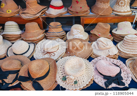 assortment of women's fabric beach hats on counter at the street market assortment of women's fabric beach hats on counter at the street market 118905044