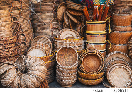 Traditional asian rattan woven wicker baskets and containers on the counter at Asian street market in Vietnam Traditional asian rattan woven wicker baskets and containers on the counter at Asian street market in Vietnam 118906516