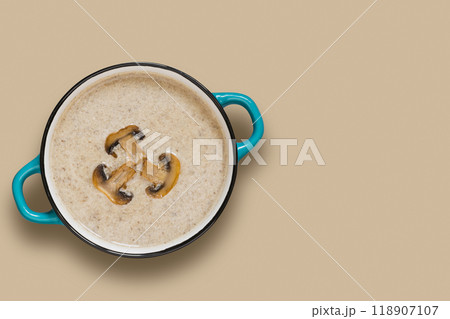 Delicious mushroom champignon cream soup with toast on grey concrete table. Horizontal mockup, view from above. Delicious mushroom champignon cream soup with toast on grey concrete table. Horizontal mockup, view from above. 118907107