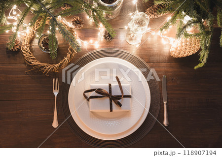 Christmas table setting with silverware, garland and dark natural evergreen decor on black table. Top view. Xmas Party. Magic night. 118907194