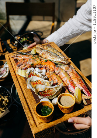 Seafood platter with shrimp, grilled fish, oysters. Menu design, food advertising, culinary projects 118911107