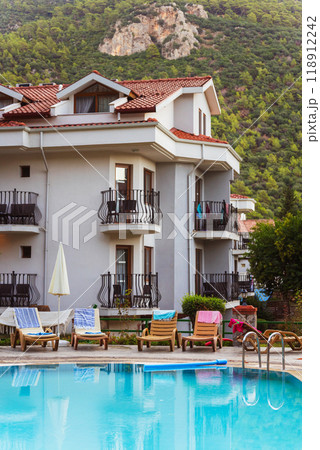 spacious swimming pool near a residential building in mountains spacious swimming pool near a residential building in mountains 118912242