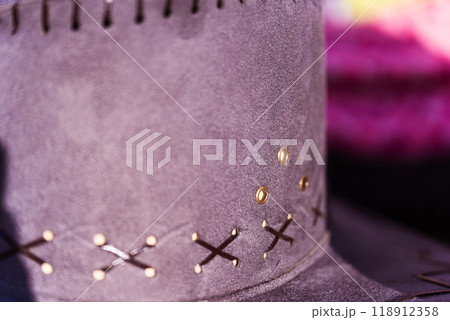 Closeup of a cowboy hat with black stitching detail 118912358