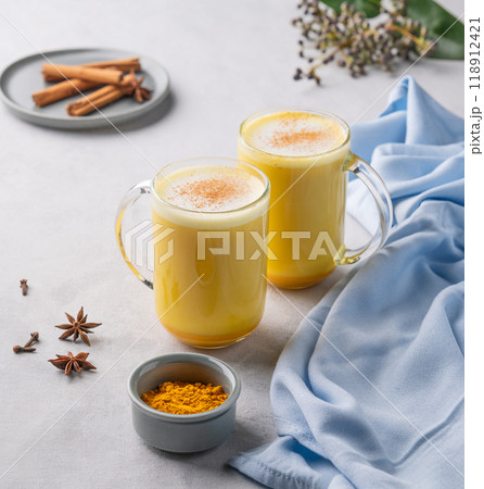 Turmeric golden milk latte with spices and honey. Detox, immunity boosting, anti-inflammatory drink Turmeric golden milk latte with spices and honey. Detox, immunity boosting, anti-inflammatory drink 118912421